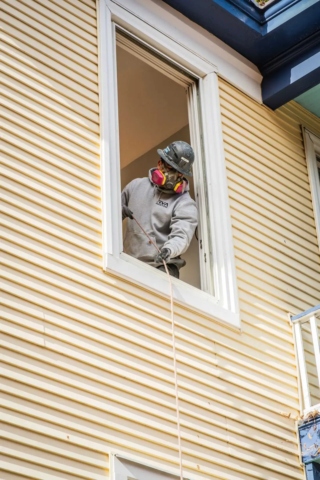 Worker breaking up a floor with a jackhammer during demolition