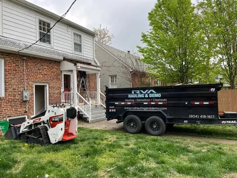 Crew loading construction debris into a trailer
