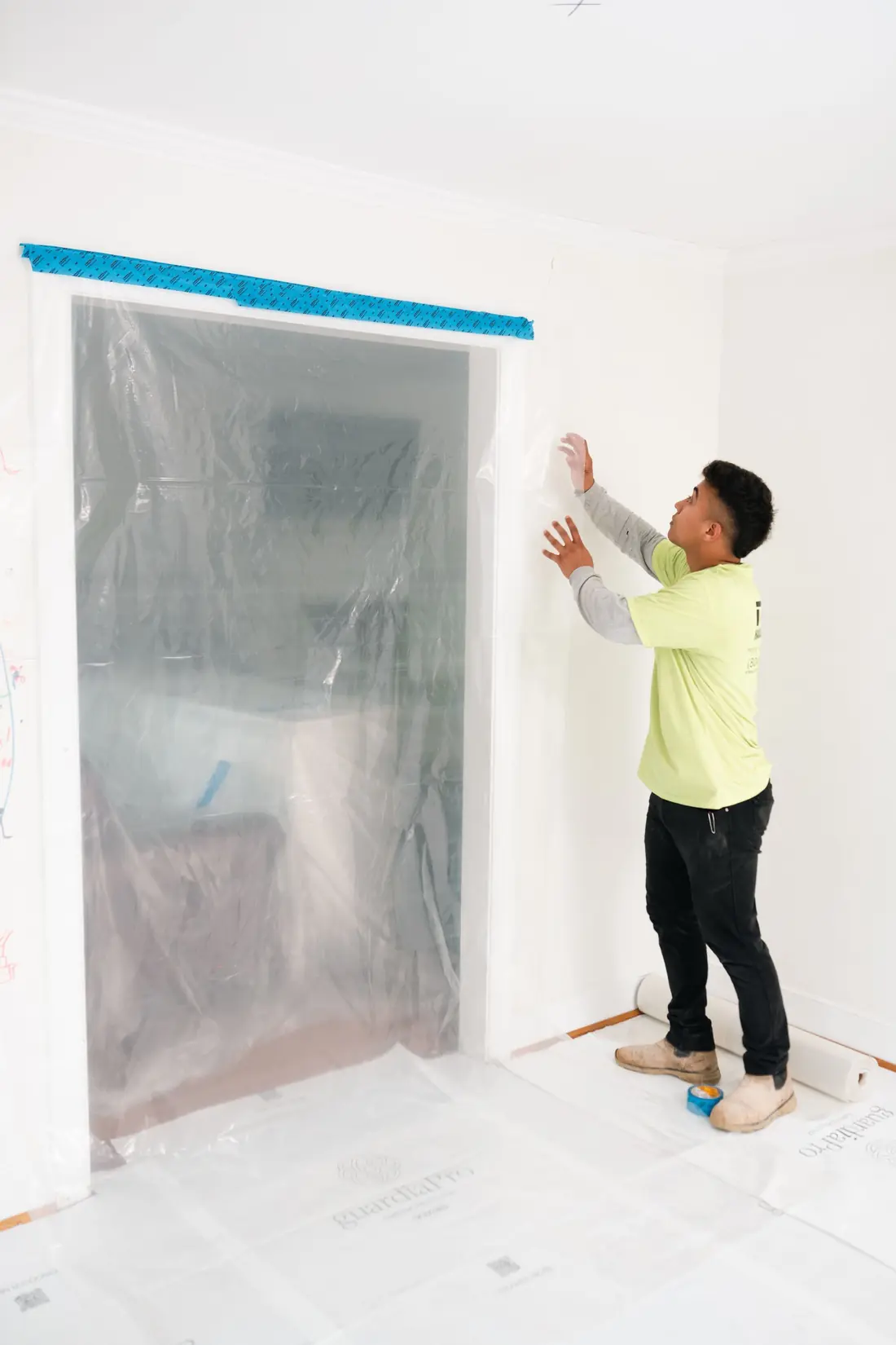 Plastic sheeting hung across a doorway for dust containment