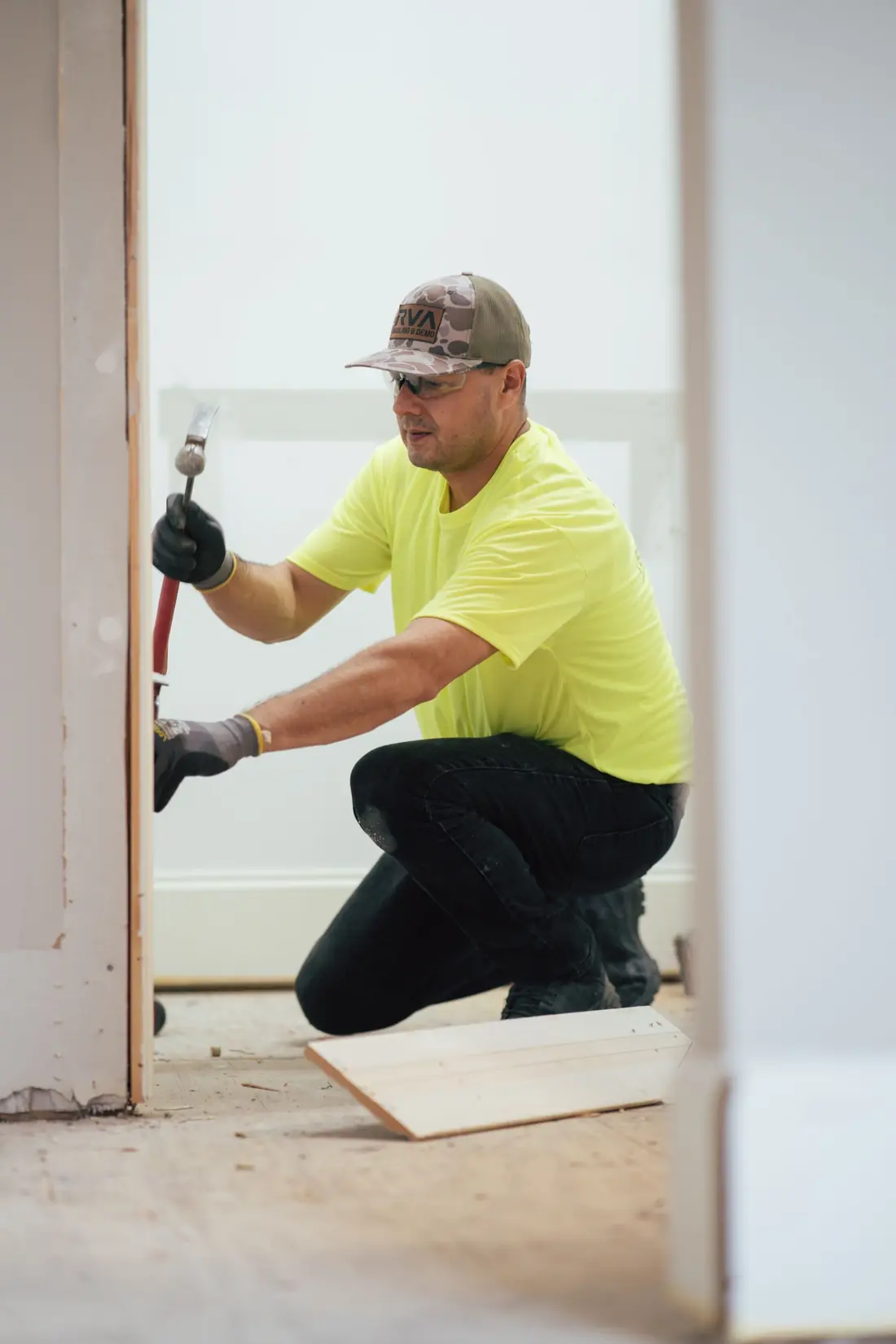Worker breaking out concrete steps on a residential property
